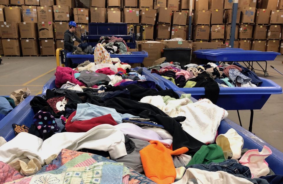 Piles of sorted clothing at Goodwill Industries of Greater Grand Rapids are prepared for recycling