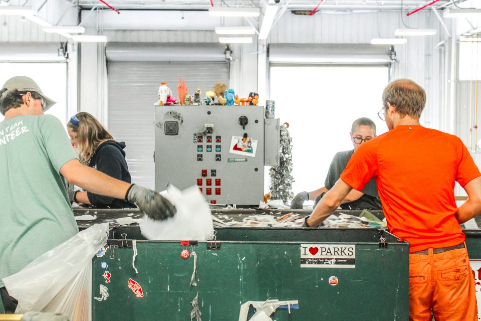 Line workers sort recycleable materials at Michigan State University Surplus Store and Recycling Center