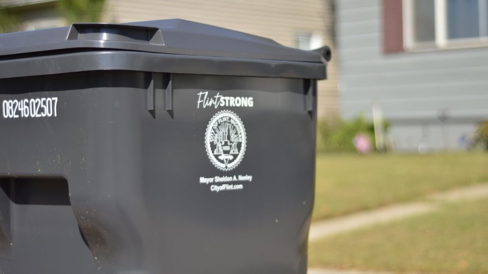 A trash bin outside a house